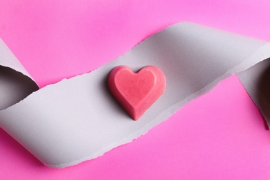 Composition with heart shaped berry ice cube on color background, top view