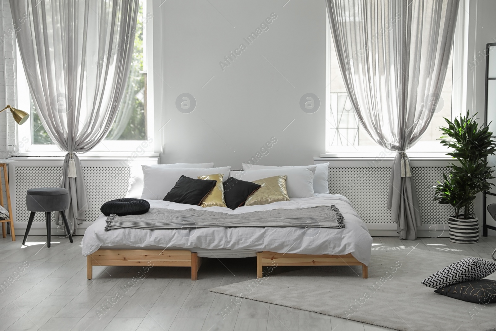 Photo of Stylish modern room interior with comfortable double bed