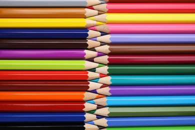 Many colorful wooden pencils as background, top view