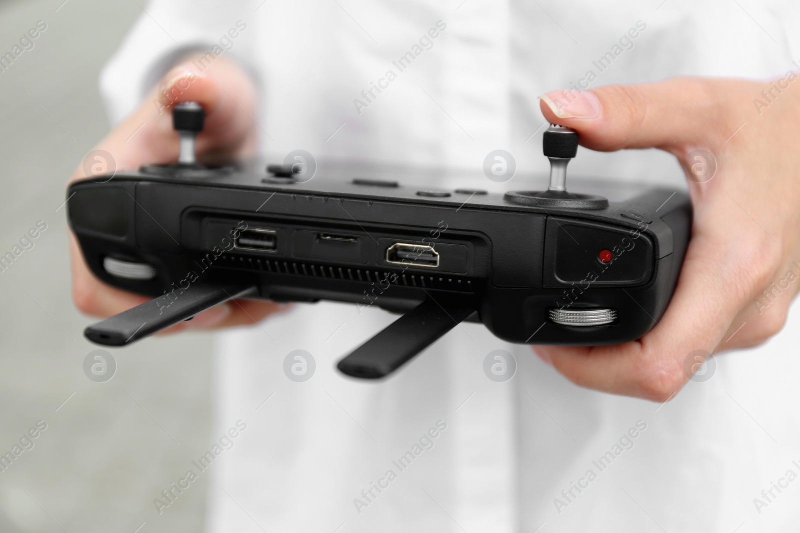 Photo of Woman with modern drone controller outdoors, closeup