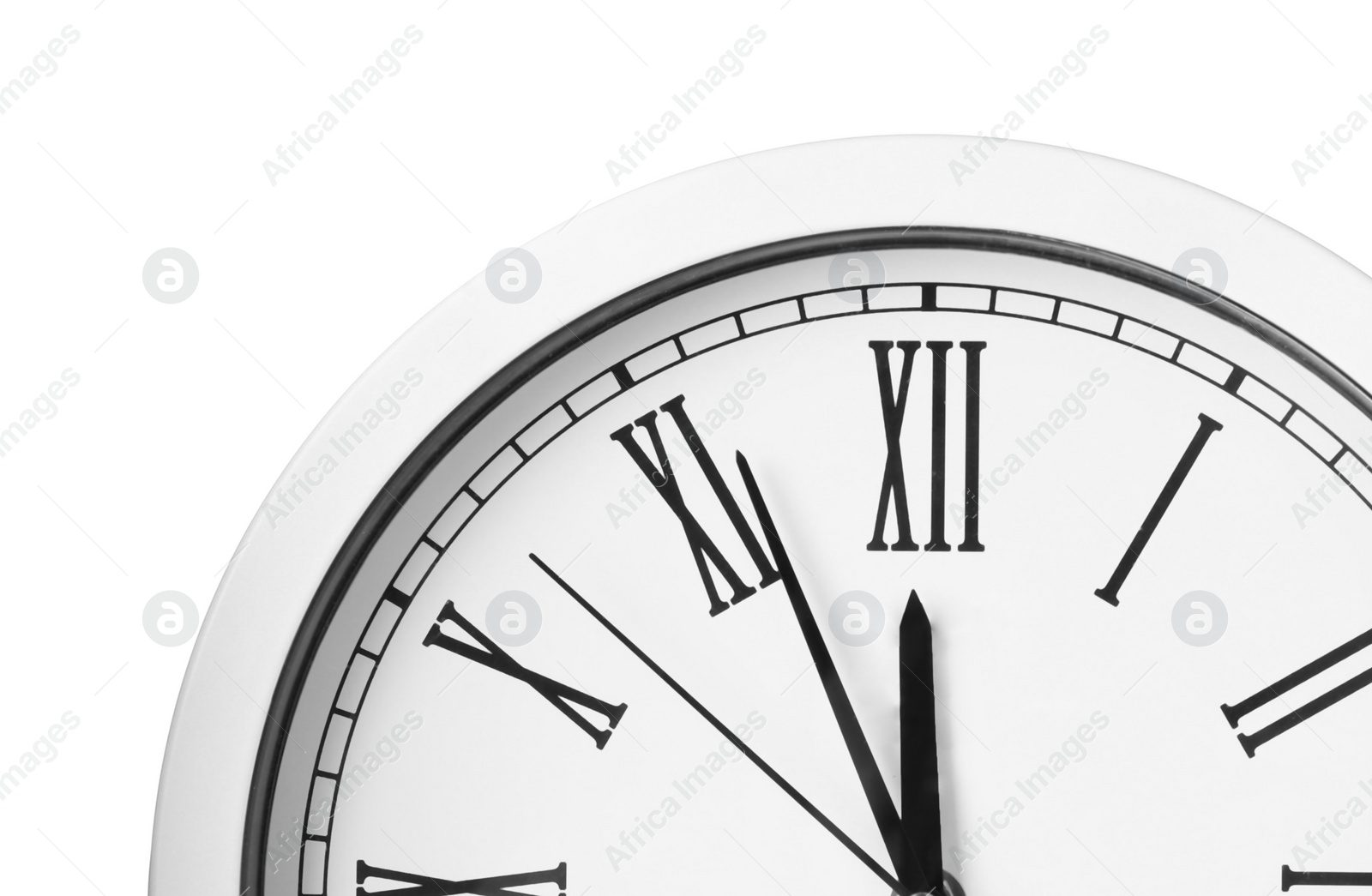 Photo of Clock showing five minutes until midnight on white background, closeup. New Year countdown