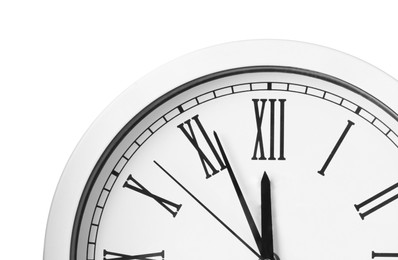 Photo of Clock showing five minutes until midnight on white background, closeup. New Year countdown