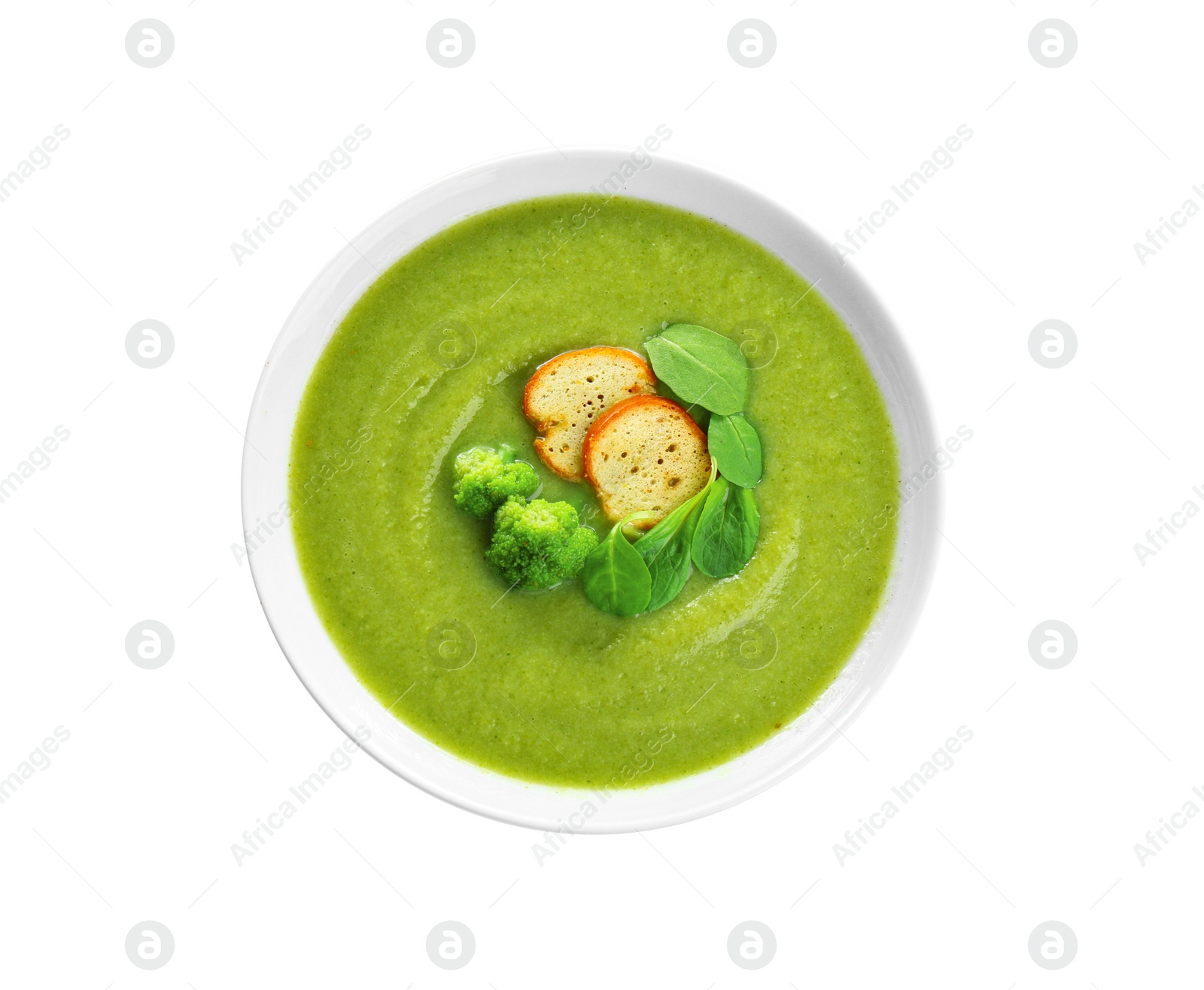 Photo of Bowl of broccoli cream soup with croutons on white background, top view