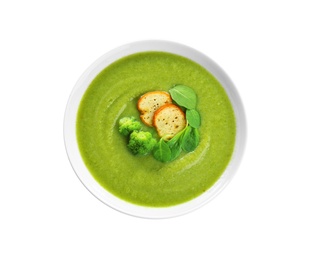 Photo of Bowl of broccoli cream soup with croutons on white background, top view