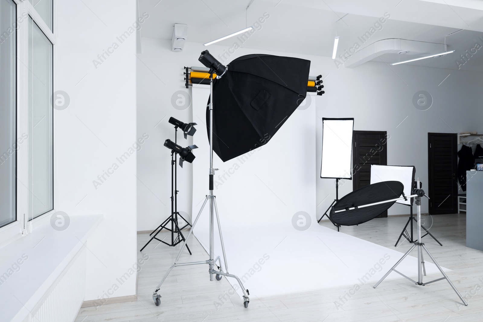 Photo of Interior of modern photo studio with professional lighting equipment