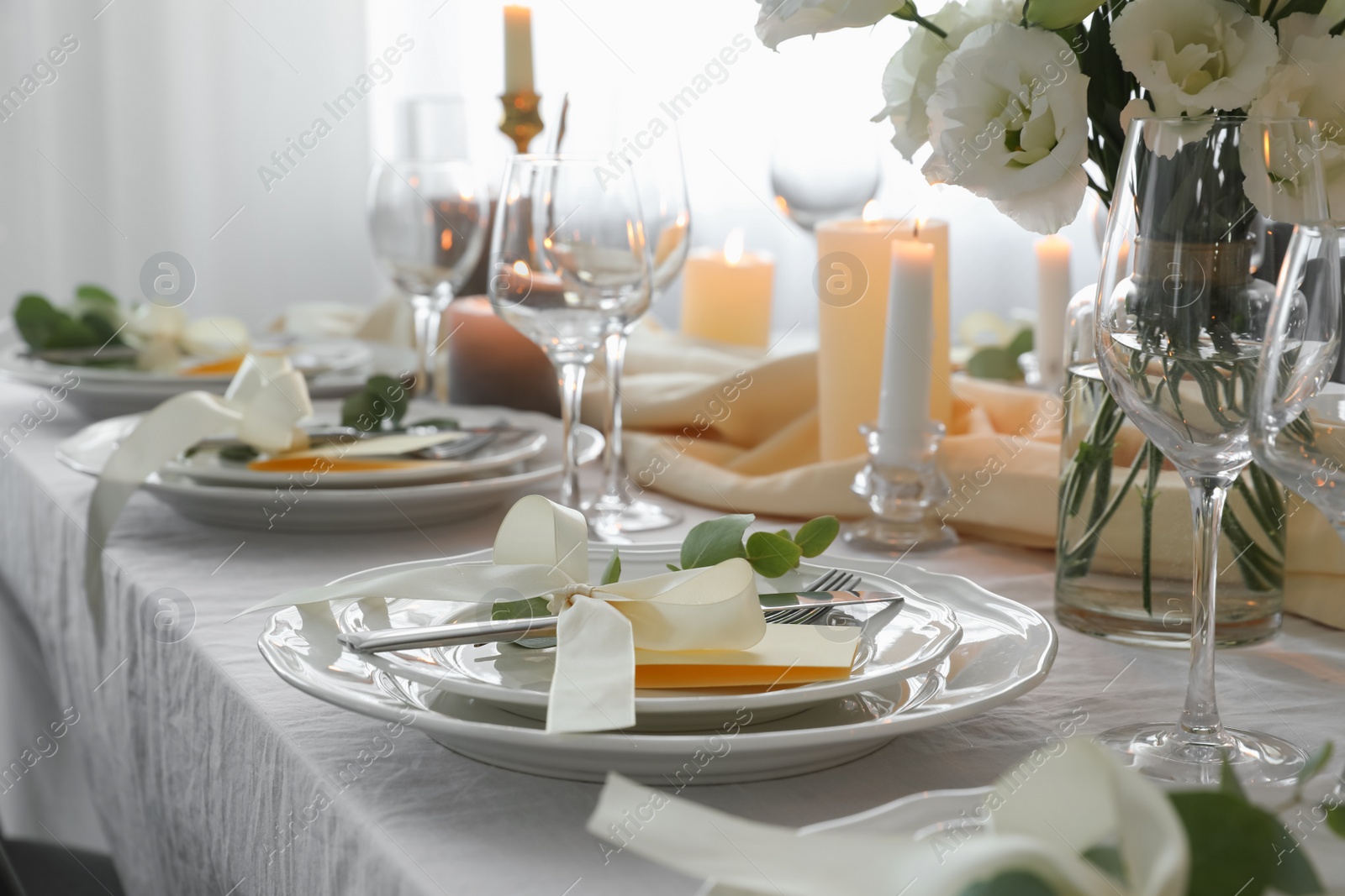 Photo of Festive table setting with beautiful floral decor in restaurant