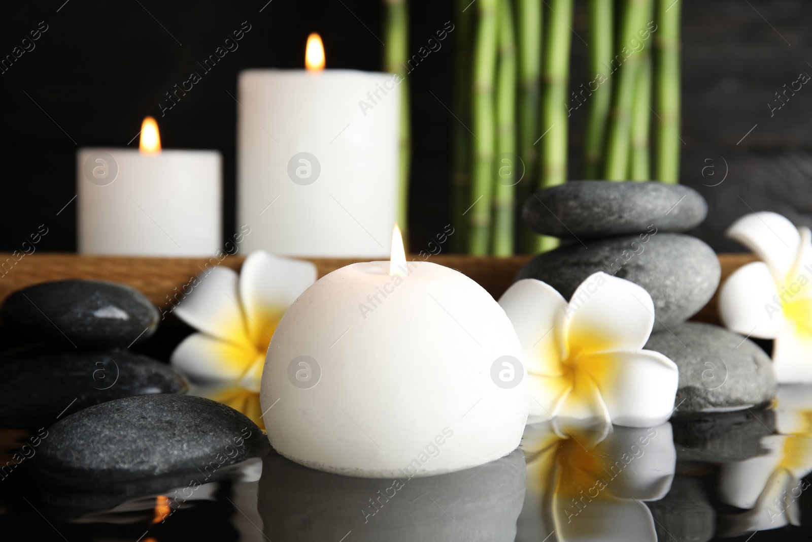 Photo of Spa composition with burning candle in water