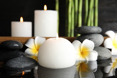 Photo of Spa composition with burning candle in water