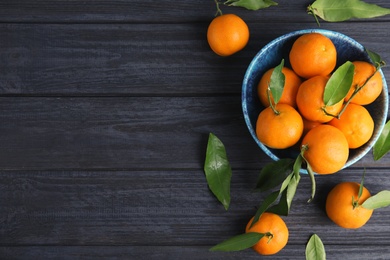 Flat lay composition with fresh ripe tangerines and space for text on wooden background