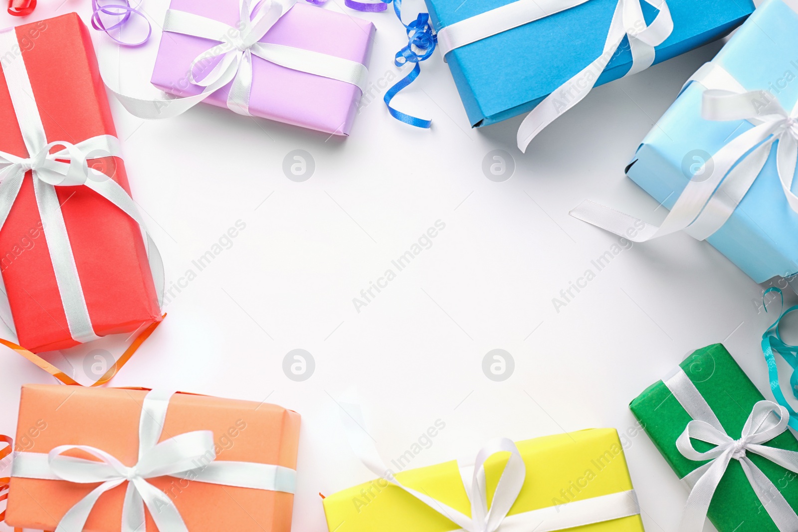 Photo of Bright gift boxes on white background, top view. Rainbow colors
