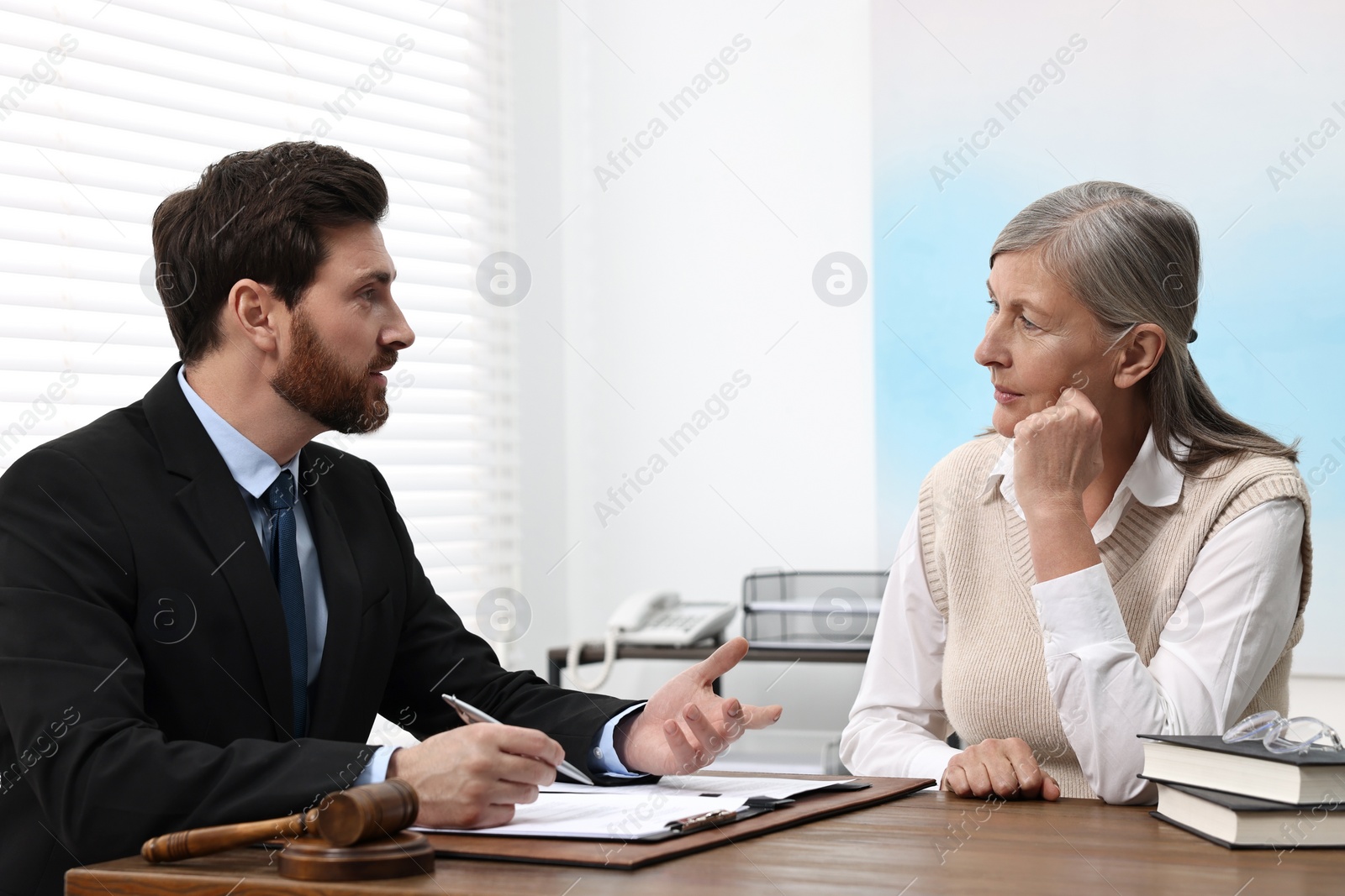 Photo of Senior woman having meeting with lawyer in office