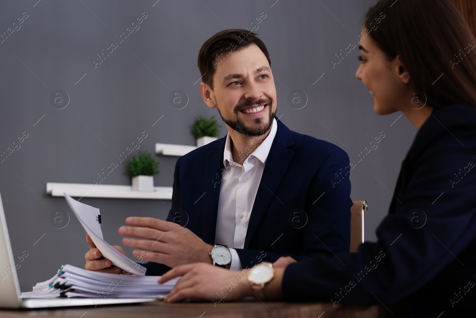 Photo of Office employees working with documents at table indoors