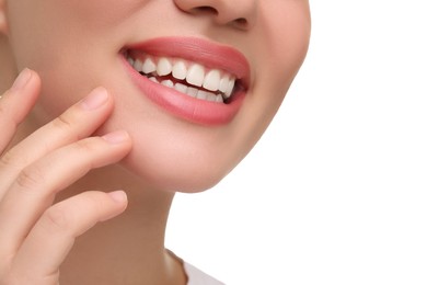 Woman with clean teeth smiling on white background, closeup