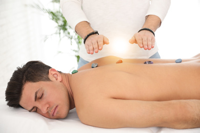 Photo of Man during crystal healing session in therapy room