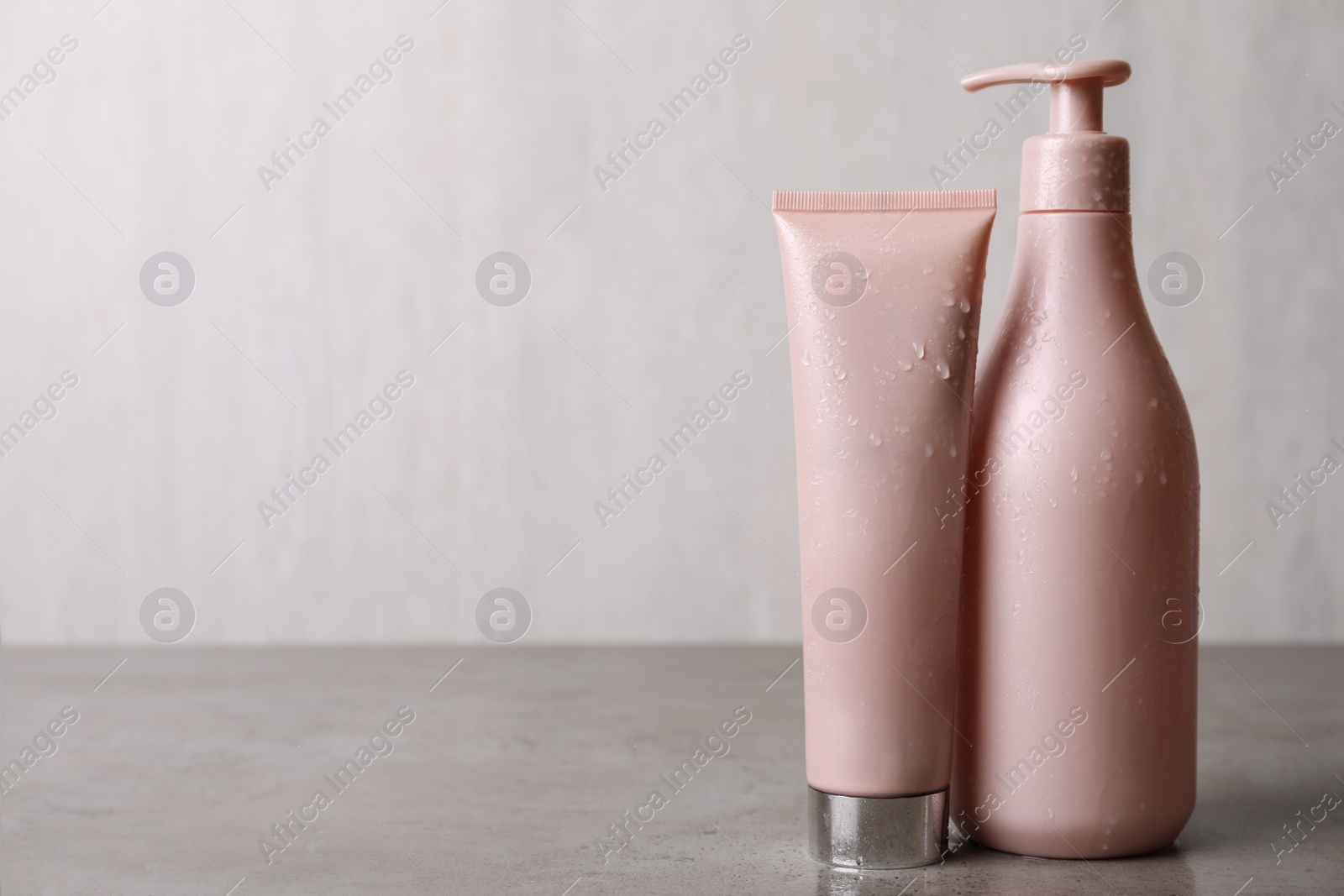 Photo of Different hair products on grey table. Space for text