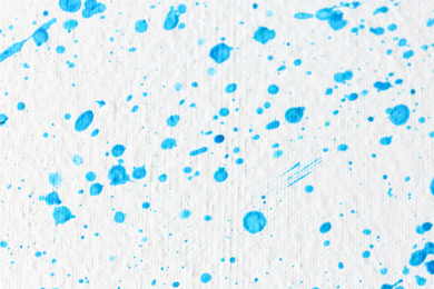 Photo of Blue paint splashes on white canvas as background. Art and creativity