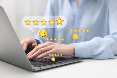 Woman leaving service feedback using laptop at table, closeup. Emoticons and stars near device