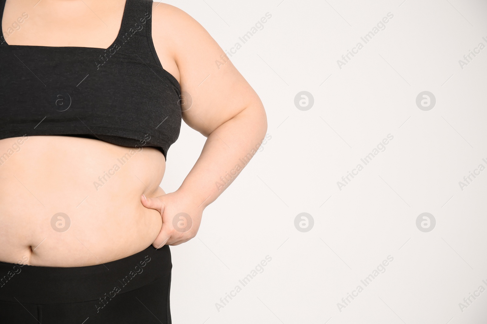 Photo of Overweight woman on light background