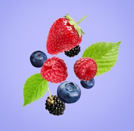 Image of Many different fresh berries falling on light slate blue color background