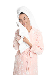 Young woman wiping face with towel on white background