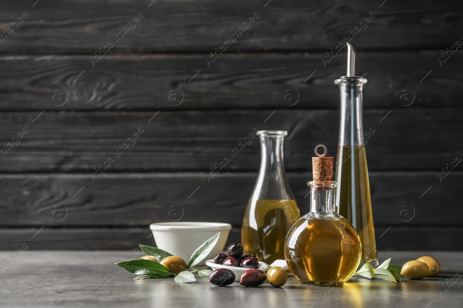 Photo of Composition with fresh olive oil on table