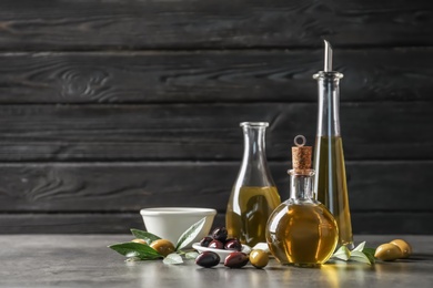 Photo of Composition with fresh olive oil on table