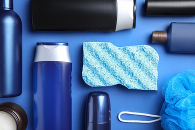 Photo of Flat lay composition with men's cosmetic products on blue background