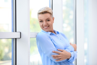 Photo of Portrait of attractive woman near window at office