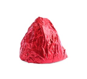Photo of Tasty candy in red wrapper isolated on white