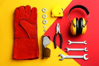 Photo of Flat lay composition with construction tools on color background