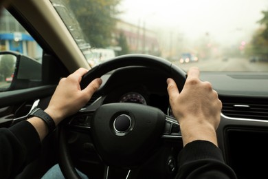 Photo of Man driving his car, closeup. Traffic rules