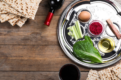 Photo of Flat lay composition with Passover Seder plate (keara) on wooden table, space for text. Pesah celebration