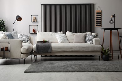 Photo of Comfortable sofas in stylish living room. Interior design
