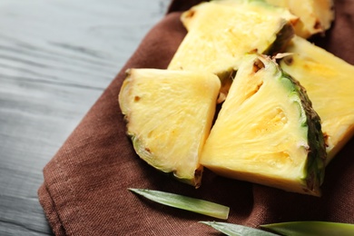Photo of Fresh sliced pineapple on napkin, closeup