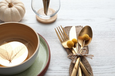 Photo of Autumn table setting and pumpkin on white wooden background, closeup