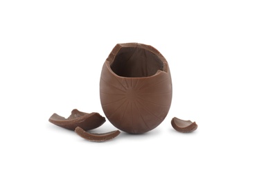 Broken milk chocolate egg on white background