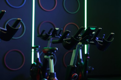 Photo of Many exercise bikes in fitness club. Indoor cycling class