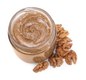 Photo of Tasty nut paste in jar and walnuts isolated on white