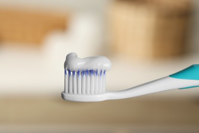 Photo of Plastic toothbrush with paste on blurred background, closeup