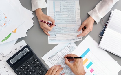 Photo of Tax accountants working with documents at table