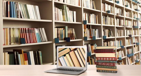 Image of Digital library concept. Modern laptop on table and shelves with books indoors