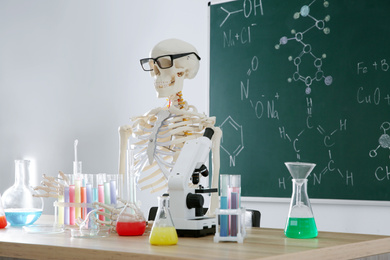 Photo of Skeleton and different chemistry glassware in classroom