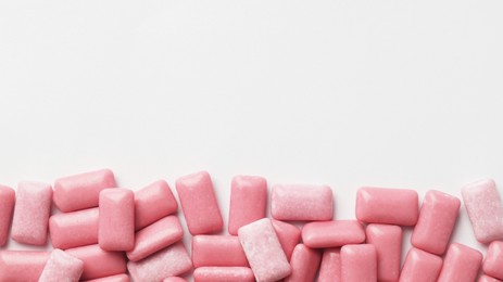 Photo of Sweet chewing gums on white background, top view. Space for text