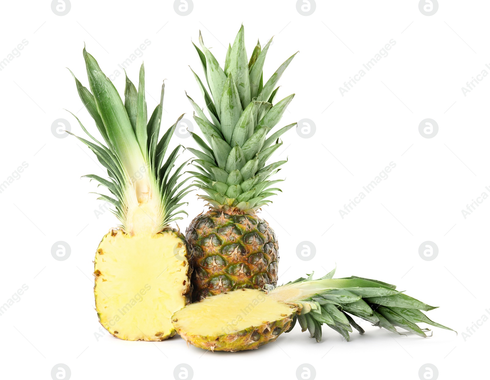 Photo of Whole and cut juicy pineapples isolated on white