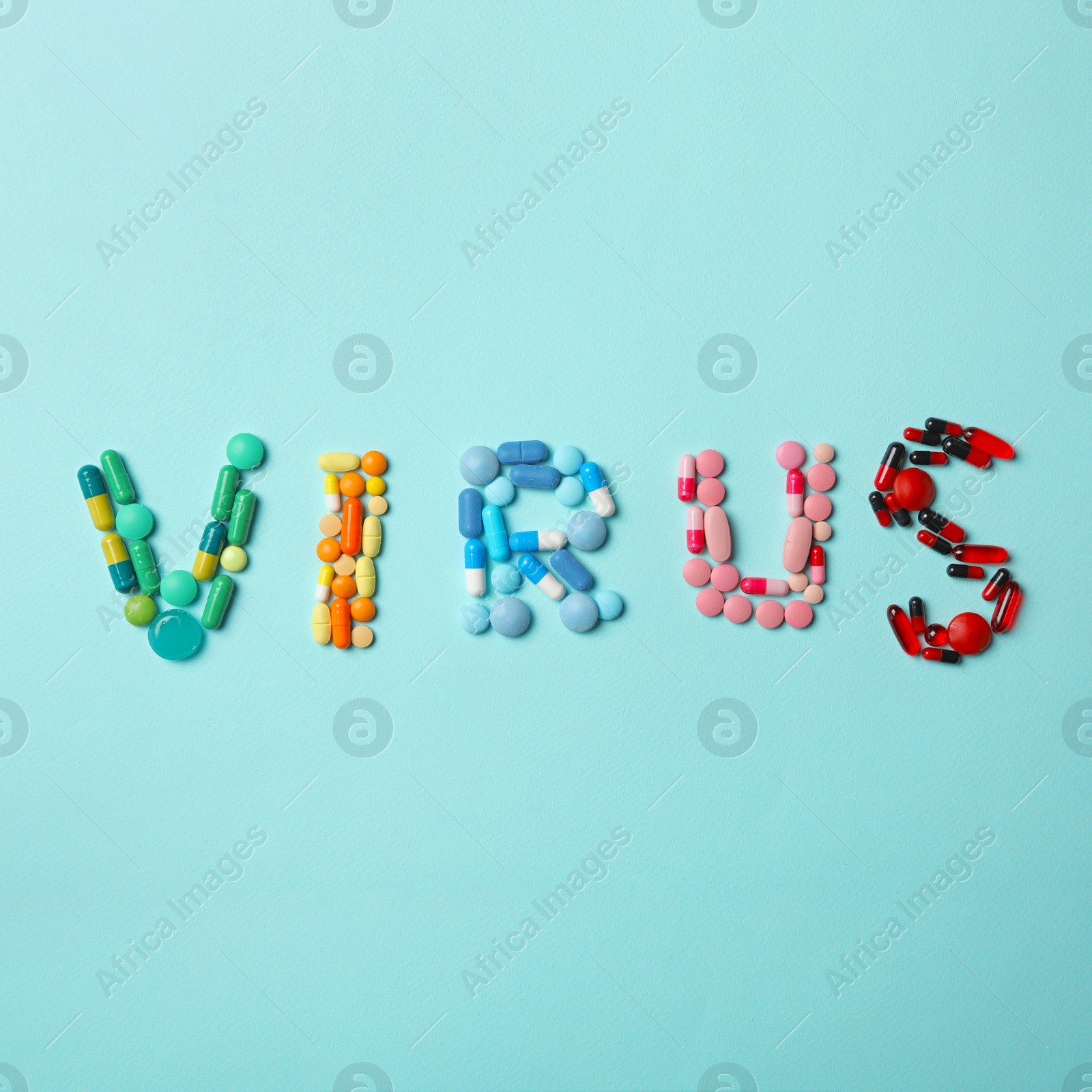 Photo of Word VIRUS made of pills on light blue background, top view