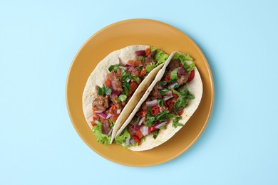 Photo of Delicious tacos with meat and vegetables on table, top view