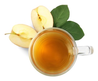 Photo of Glass mug with delicious cider, pieces of ripe apple and leaves on white background, top view