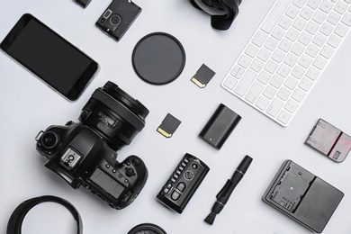 Photo of Flat lay composition with equipment for professional photographer on white background