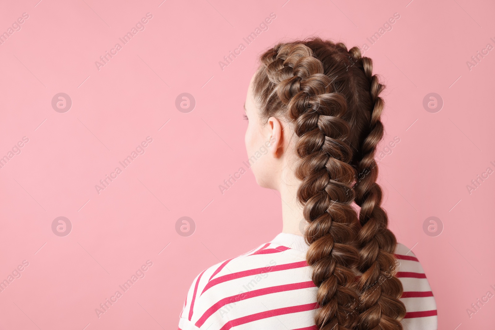 Photo of Woman with braided hair on pink background