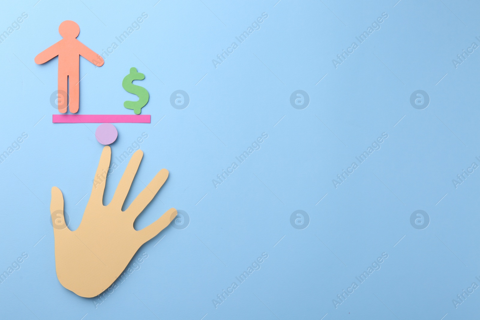 Photo of Equality concept. Paper human figure, dollar sign, seesaw scale and palm on light blue background, top view. Space for text